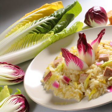 Prepare a delicious risotto with Belgian endive and Chioggia red lettuce, enriched with Parmesan and slowly cooked in vegetable broth. Serve it with a twist of chopped nuts for a delightful contrast of textures. A creamy and enticing dish, perfect for an irresistible culinary experience. Enjoy!